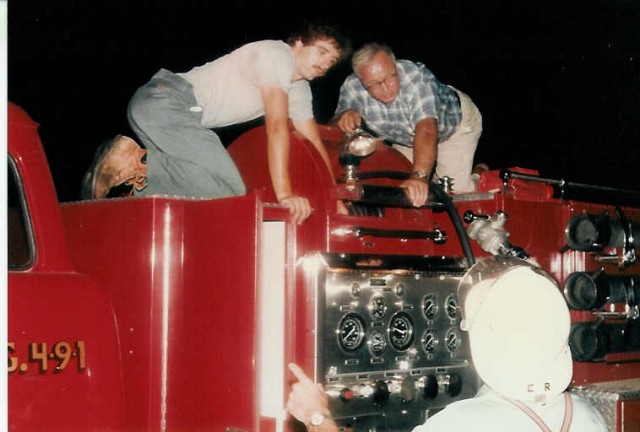 Dale Martin, Frank Kurtz & Elam Riehl reload the high pressure booster line back on the '79 pumper at a fire on Limeville Road... 8/19/85